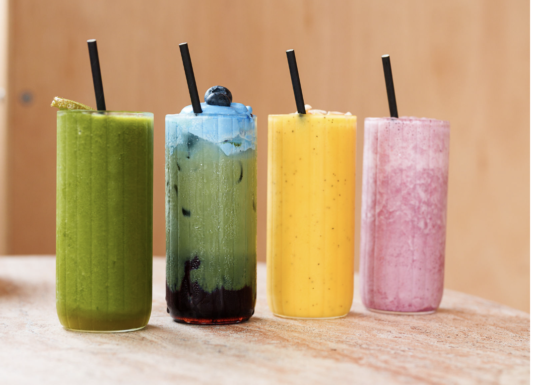 Four freshly blended smoothies with black straws on the ELEMENTS café counter in St Ives